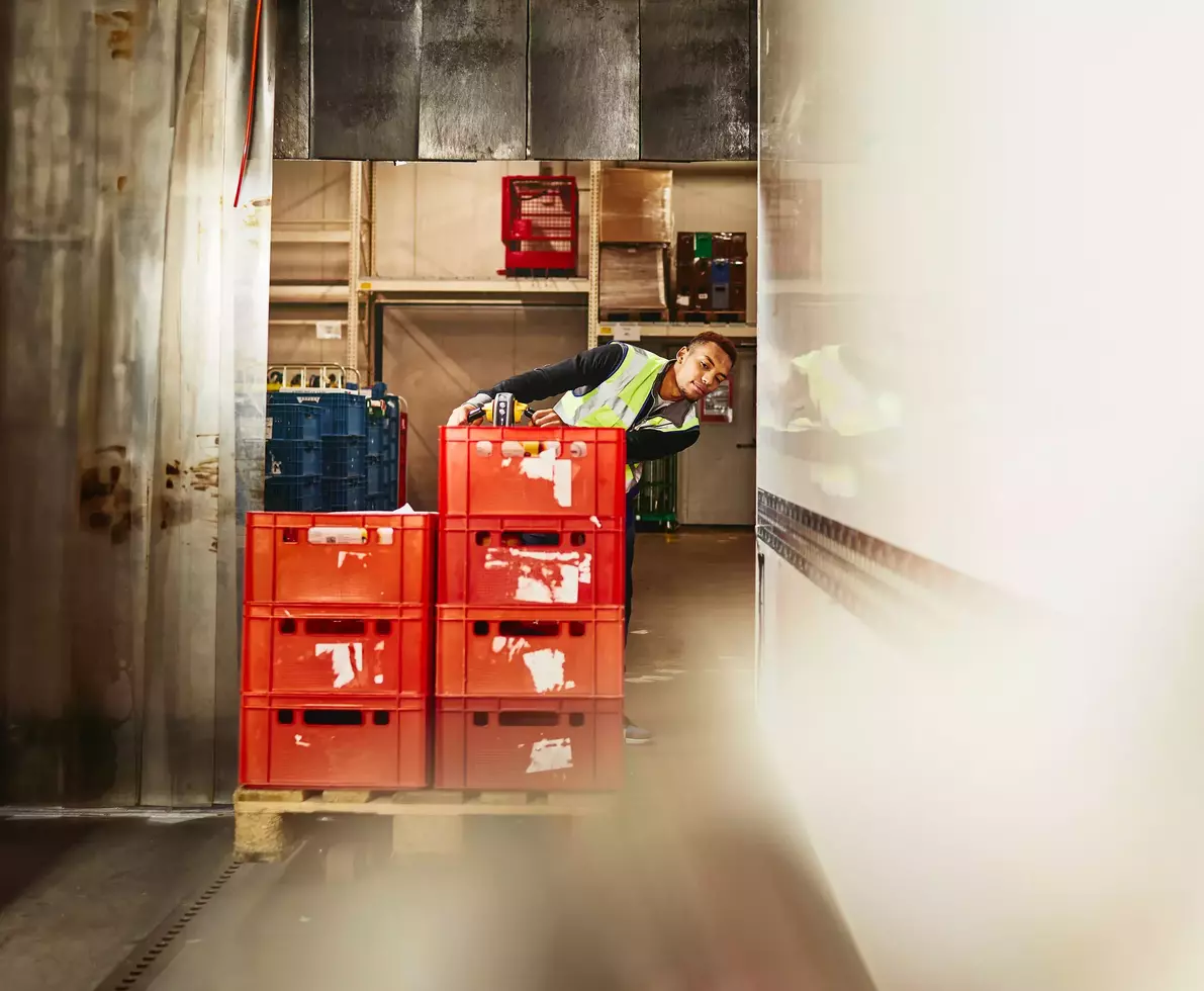 male unloading crates from truck